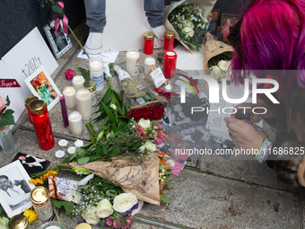 A hundred fans of former One Direction member Liam Payne gather to hold a memorial tribute at Dom Square following the death of the singer i...