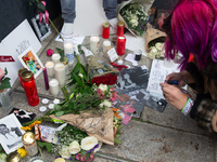 A hundred fans of former One Direction member Liam Payne gather to hold a memorial tribute at Dom Square following the death of the singer i...