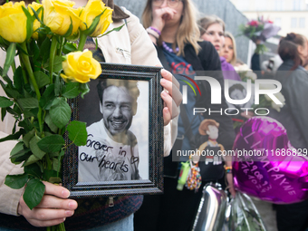 A hundred fans of former One Direction member Liam Payne gather to hold a memorial tribute at Dom Square following the death of the singer i...