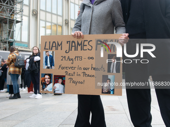 A hundred fans of former One Direction member Liam Payne gather to hold a memorial tribute at Dom Square following the death of the singer i...