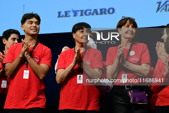 Volunteers participate in the closing night of the Lyon Light Festival in Lyon, France, on October 20, 2024. 