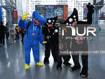 A family dresses as Poppy Playtime, Kelly Willy, and Huggy Wuggy from the video game Poppy Playtime for New York Comic Con at the Javits Cen...