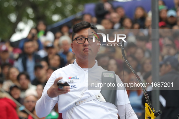 Woojin Kim of Korea competes against Thomas Chirault of France (not in picture) during the Men's recurve quarterfinals match on the final da...