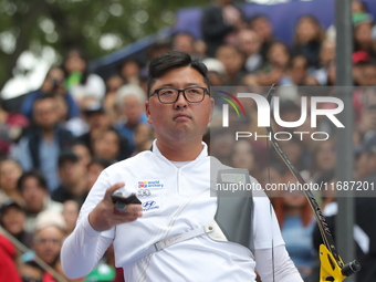 Woojin Kim of Korea competes against Thomas Chirault of France (not in picture) during the Men's recurve quarterfinals match on the final da...