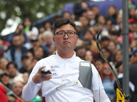 Woojin Kim of Korea competes against Thomas Chirault of France (not in picture) during the Men's recurve quarterfinals match on the final da...