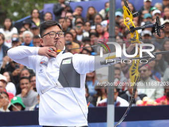 Woojin Kim of Korea competes against Thomas Chirault of France (not in picture) during the Men's recurve quarterfinals match on the final da...