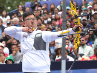 Woojin Kim of Korea competes against Thomas Chirault of France (not in picture) during the Men's recurve quarterfinals match on the final da...