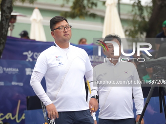 Woojin Kim of Korea competes against Thomas Chirault of France (not in picture) during the Men's recurve quarterfinals match on the final da...