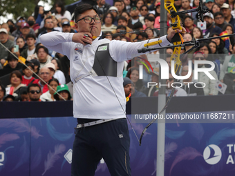 Woojin Kim of Korea competes against Thomas Chirault of France (not in picture) during the Men's recurve quarterfinals match on the final da...