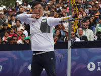 Woojin Kim of Korea competes against Thomas Chirault of France (not in picture) during the Men's recurve quarterfinals match on the final da...