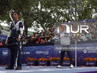 Woojin Kim of Korea and Thomas Chirault of France compete during the Men's recurve quarterfinals match on the final day of the Tlaxcala 2024...