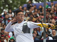 Woojin Kim of Korea competes against Thomas Chirault of France (not in picture) during the Men's recurve quarterfinals match on the final da...