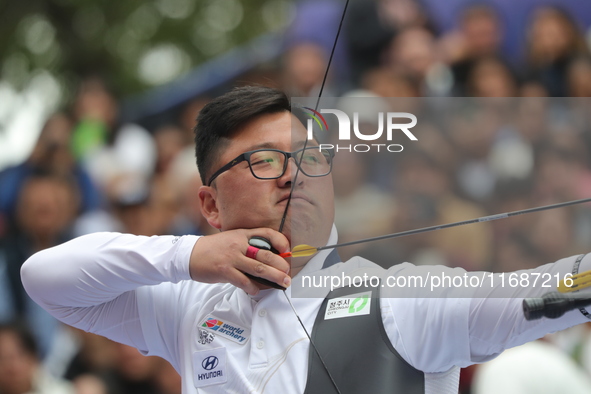 Woojin Kim of Korea competes against Thomas Chirault of France (not in picture) during the Men's recurve quarterfinals match on the final da...