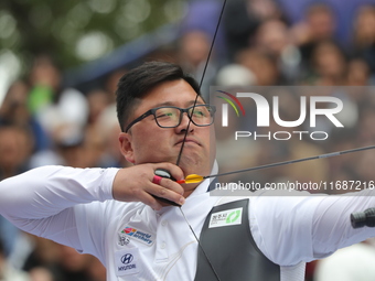 Woojin Kim of Korea competes against Thomas Chirault of France (not in picture) during the Men's recurve quarterfinals match on the final da...