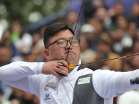 Woojin Kim of Korea competes against Thomas Chirault of France (not in picture) during the Men's recurve quarterfinals match on the final da...