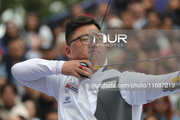 Woojin Kim of Korea competes against Thomas Chirault of France (not in picture) during the Men's recurve quarterfinals match on the final da...