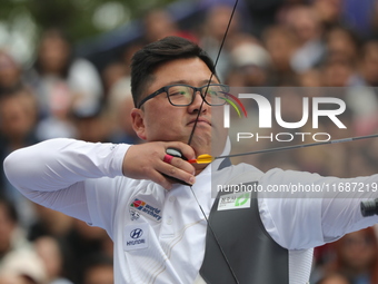 Woojin Kim of Korea competes against Thomas Chirault of France (not in picture) during the Men's recurve quarterfinals match on the final da...