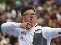 Woojin Kim of Korea competes against Thomas Chirault of France (not in picture) during the Men's recurve quarterfinals match on the final da...