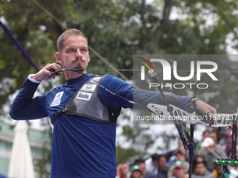 Marcus D'Almeida of Brazil competes against Andres Temino of Spain (not in picture) during the Men's recurve quarterfinals match on the fina...