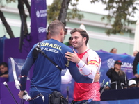 Marcus D'Almeida of Brazil and Andres Temino of Spain compete during the Men's recurve quarterfinals match on the final day of the Tlaxcala...