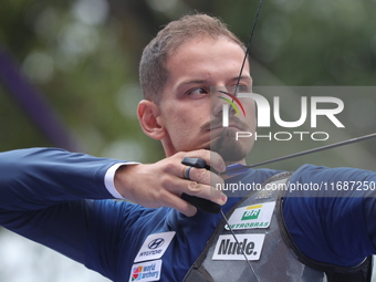 Marcus D'Almeida of Brazil competes against Andres Temino of Spain (not in picture) during the Men's recurve quarterfinals match on the fina...