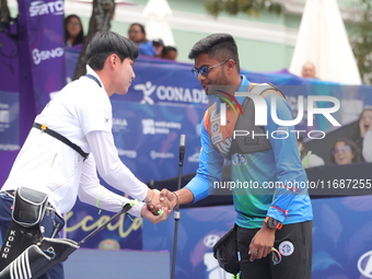 Woo-Seok Lee of Korea and Dhiraj Bommadevara of India compete during the Men's recurve quarterfinals match on the final day of the Tlaxcala...