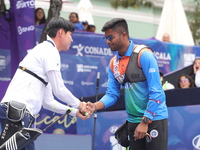 Woo-Seok Lee of Korea and Dhiraj Bommadevara of India compete during the Men's recurve quarterfinals match on the final day of the Tlaxcala...