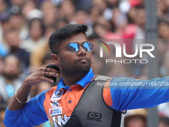 Dhiraj Bommadevara of India competes against Woo-Seok Lee of Korea (not in picture) during the Men's recurve quarterfinals match on the fina...