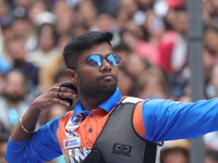 Dhiraj Bommadevara of India competes against Woo-Seok Lee of Korea (not in picture) during the Men's recurve quarterfinals match on the fina...