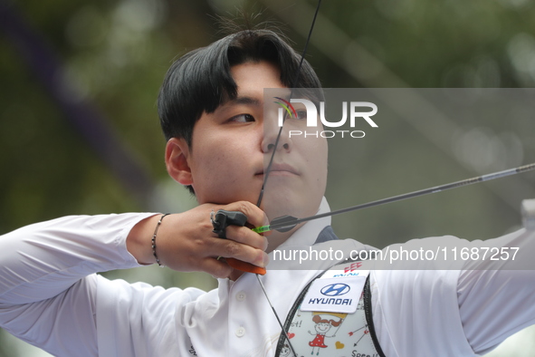 Woo-Seok Lee of Korea competes against Dhiraj Bommadevara of India (not in picture) during the Men's recurve quarterfinals match on the fina...