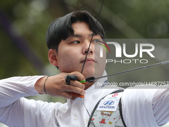 Woo-Seok Lee of Korea competes against Dhiraj Bommadevara of India (not in picture) during the Men's recurve quarterfinals match on the fina...