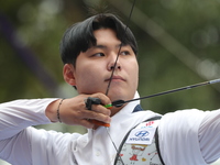 Woo-Seok Lee of Korea competes against Dhiraj Bommadevara of India (not in picture) during the Men's recurve quarterfinals match on the fina...