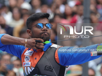 Dhiraj Bommadevara of India competes against Woo-Seok Lee of Korea (not in picture) during the Men's recurve quarterfinals match on the fina...