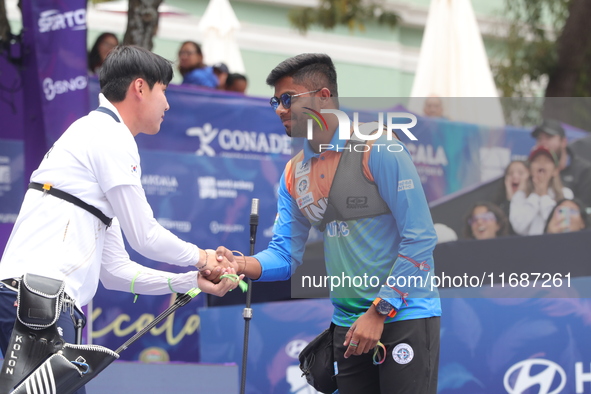 Woo-Seok Lee of Korea and Dhiraj Bommadevara of India compete during the Men's recurve quarterfinals match on the final day of the Tlaxcala...