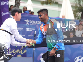 Woo-Seok Lee of Korea and Dhiraj Bommadevara of India compete during the Men's recurve quarterfinals match on the final day of the Tlaxcala...