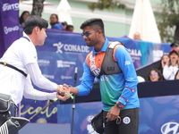 Woo-Seok Lee of Korea and Dhiraj Bommadevara of India compete during the Men's recurve quarterfinals match on the final day of the Tlaxcala...