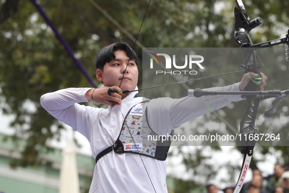 Woo-Seok Lee of Korea competes against Dhiraj Bommadevara of India (not in picture) during the Men's recurve quarterfinals match on the fina...