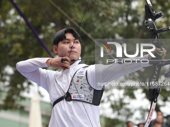 Woo-Seok Lee of Korea competes against Dhiraj Bommadevara of India (not in picture) during the Men's recurve quarterfinals match on the fina...