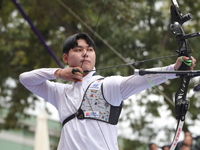 Woo-Seok Lee of Korea competes against Dhiraj Bommadevara of India (not in picture) during the Men's recurve quarterfinals match on the fina...