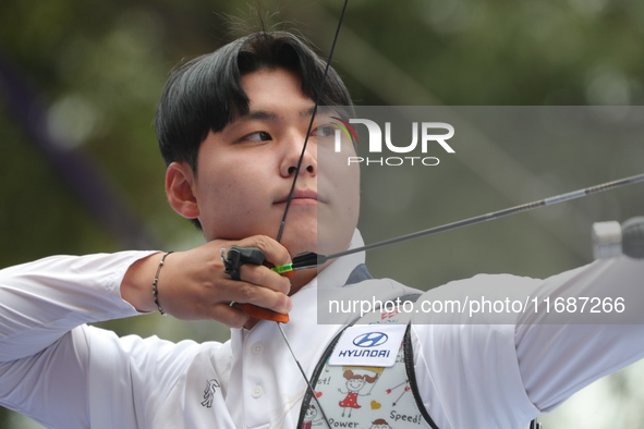 Woo-Seok Lee of Korea competes against Dhiraj Bommadevara of India (not in picture) during the Men's recurve quarterfinals match on the fina...