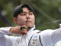 Woo-Seok Lee of Korea competes against Dhiraj Bommadevara of India (not in picture) during the Men's recurve quarterfinals match on the fina...