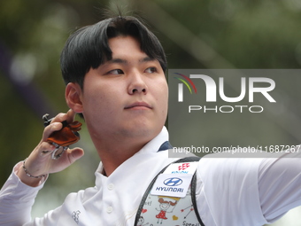 Woo-Seok Lee of Korea competes against Dhiraj Bommadevara of India (not in picture) during the Men's recurve quarterfinals match on the fina...