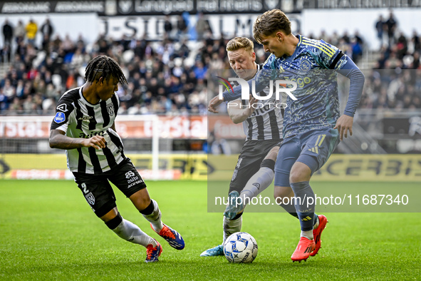 Heracles Almelo defender Mimeirhel Benita, Heracles Almelo midfielder Brian de Keersmaecker, and AFC Ajax Amsterdam forward Mika Godts parti...