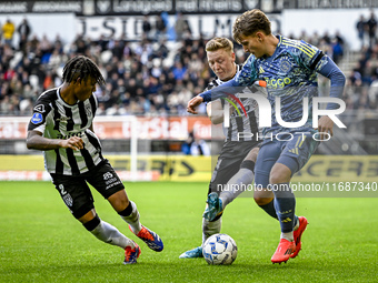 Heracles Almelo defender Mimeirhel Benita, Heracles Almelo midfielder Brian de Keersmaecker, and AFC Ajax Amsterdam forward Mika Godts parti...