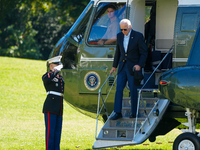 US President Joe Biden walks to the Oval Office after landing on the South Lawn of the White House in Washington, DC, on October 20, 2024, a...