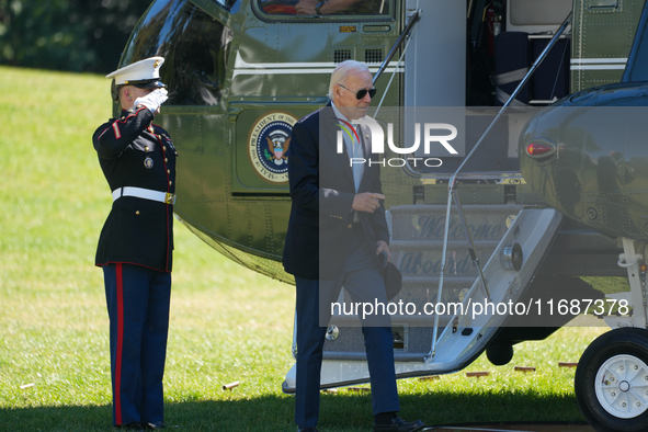 US President Joe Biden walks to the Oval Office after landing on the South Lawn of the White House in Washington, DC, on October 20, 2024, a...