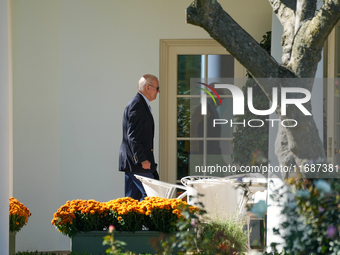 US President Joe Biden walks to the Oval Office after landing on the South Lawn of the White House in Washington, DC, on October 20, 2024, a...