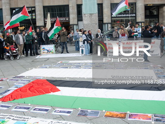 A hundred pro-Palestinian activists take part in a weekly demonstration in front of the Dom Cathedral  in Cologne, Germany, on October 20, 2...