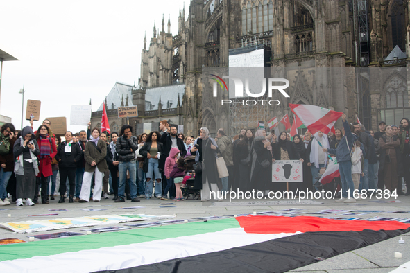 A hundred pro-Palestinian activists take part in a weekly demonstration in front of the Dom Cathedral  in Cologne, Germany, on October 20, 2...