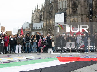 A hundred pro-Palestinian activists take part in a weekly demonstration in front of the Dom Cathedral  in Cologne, Germany, on October 20, 2...